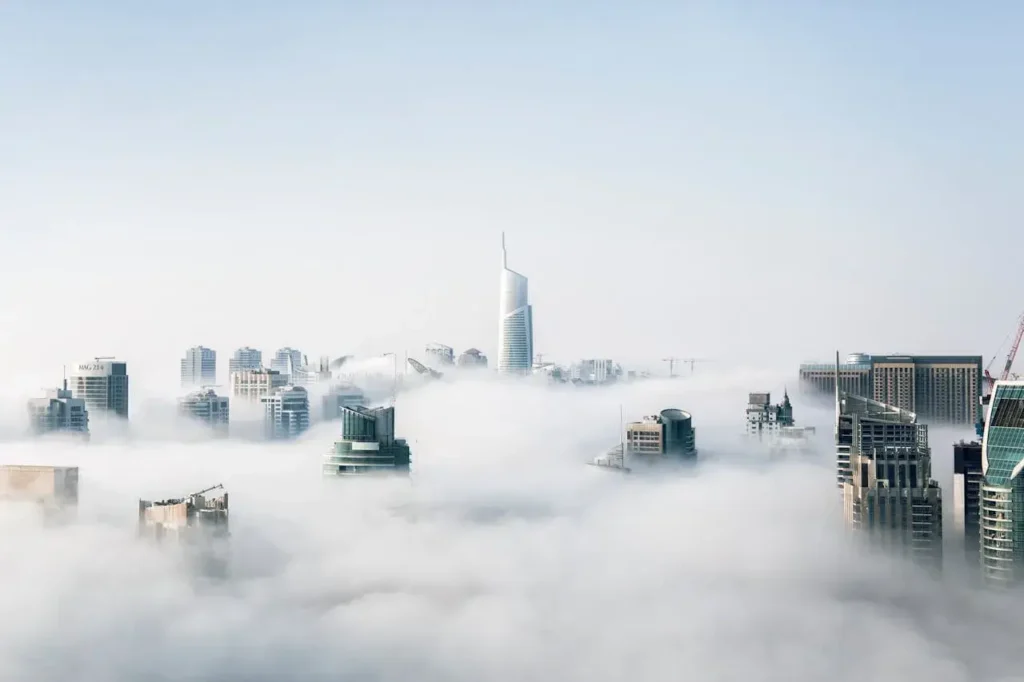 A city skyline obscured by clouds